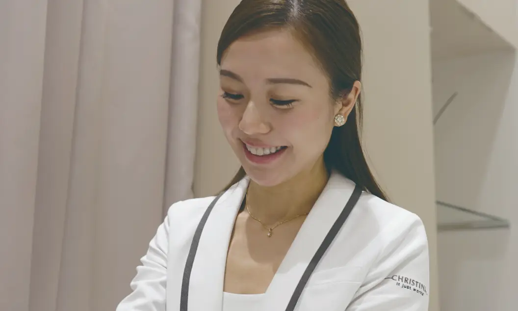 笑顔でお客様に製品を紹介するビューティーアドバイザー